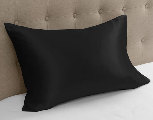 100% Mulberry Silk Pillowcase in Black against beige headboard