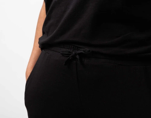 Gros plan sur la taille avec cordon de serrage du pantalon confort en jersey modal noir sur le modèle.