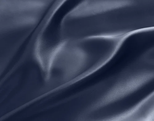 Swirled fabric on our Mulberry Silk Pillowcase in Navy to show its luxuriously smooth surface.