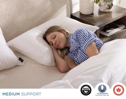 Woman resting on her side on our Opula Down Pillow.
