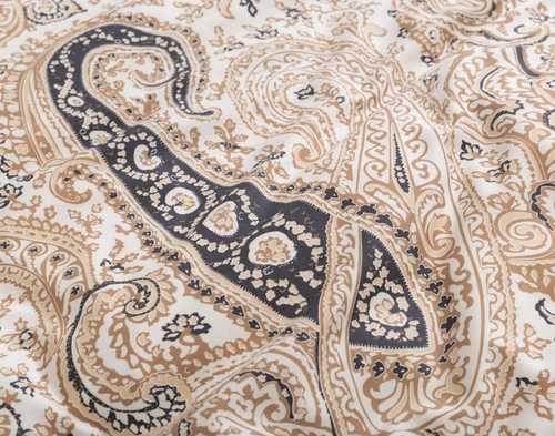 Gros plan sur l'un des motifs dessinés à la main sur la surface paisley de notre housse de couette Lansdowne.