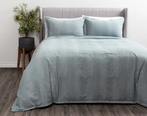 Front view of our Aquatico Duvet Cover dressed over a king bed in a plain white bedroom.