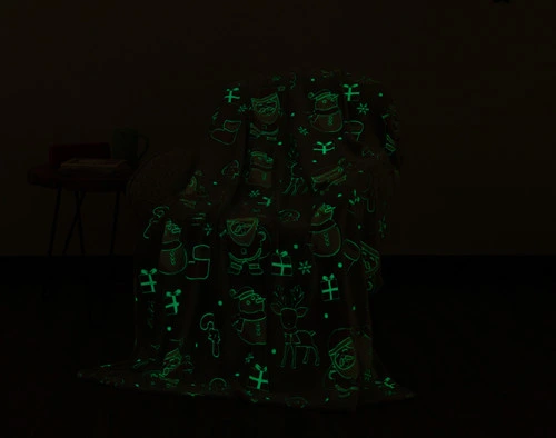 Dark view of our Santa's Holiday Glow in the Dark Fleece Throw to show its pattern glowing in a soft green.