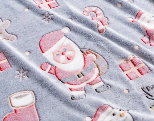 Close-up on our Santa's Holiday Glow in the Dark Fleece Throw to show its playful holiday-friendly design.