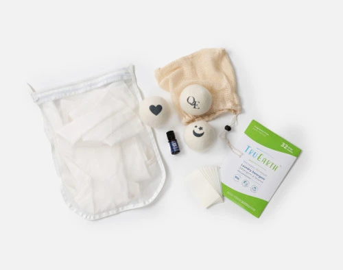 Top view of our Nature's Way Laundry Kit, including Unscented Tru Earth Laundry Strips, Mighty Mesh Laundry Bag, and Linen Love Dryer Ball Set with Good Night Essential Oil.