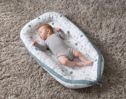 View of our Baby Nest Bed in Teal with a baby 