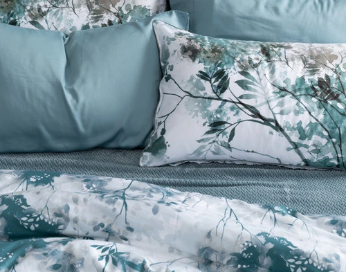 Vue du dessus de notre oreiller Canopy Pillow Sham reposant sur un drap bleu coordonné dans un lit bleu habité.