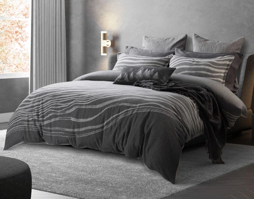 Angled view of our Cavalo Duvet Cover dressed with dark grey sheets and accessories over a queen bed in a modern bedroom.