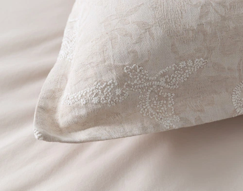 Close-up on the flanged edge border and white embroidered stitching on the corner of our Prescott Pillow Sham.