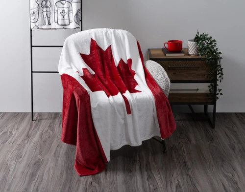 Angled view of our Canada Flag Fleece Throw draped gently over a chair.