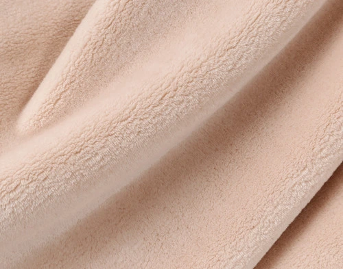 Close-up on our Velvet Plush Throw in Rose to show its soft velveteen texture.