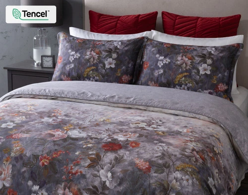 Angled view of our Renoir Floral Duvet Cover neatly made over a queen bed.