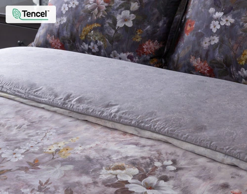 Angled view of our Renoir Floral Duvet Cover folded to show its surface and backing fabrics together.