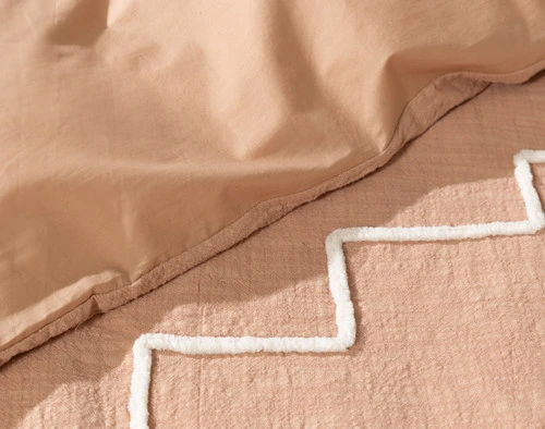 Folded edge on our Canyonlands Duvet Cover to show its smooth cotton percale backing and textural design.