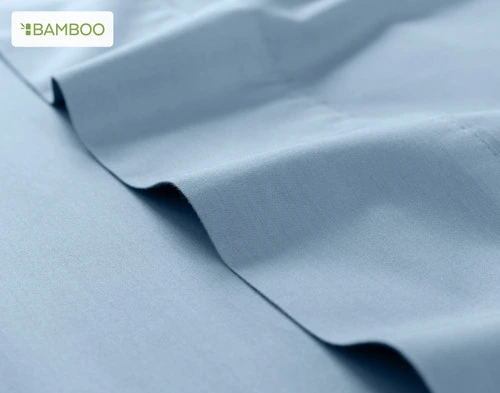 Flat sheet for our Bamboo Cotton Sheet Set in Mistral Blue ruffled lightly over a matching smooth surface.