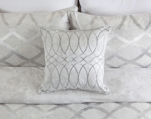 Front view of our Metropolitan Square Cushion Cover sitting on a white bed with its coordinating duvet cover.