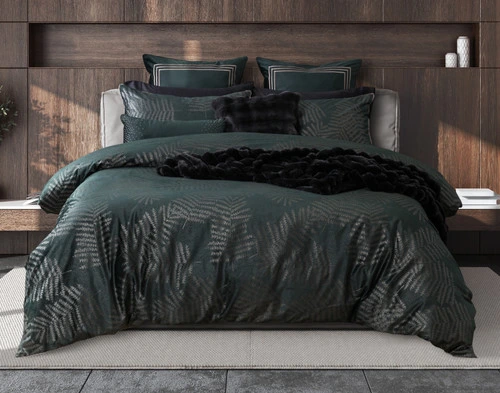 Front view of our Astra Duvet Cover with black accessory throws in an elegant wooden bedroom.