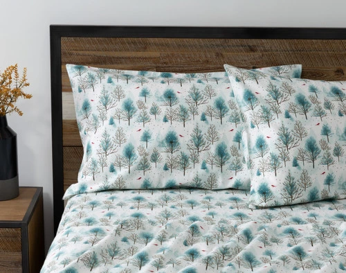 Front view of the pillowcases for our Winterscape Organic Flannel Cotton Sheet Set leaning against a headboard in a bed with matching sheets.