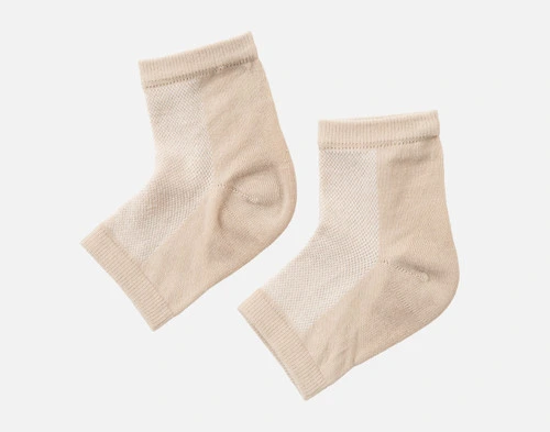 Front view of our Beige Hydraheel Spa Socks resting flat on a solid white ground.