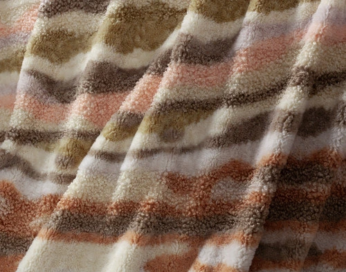 Close-up on the multicoloured waves and soft surface of our Clay Terra Nova Throw.