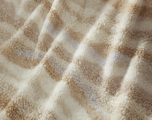 Close-up on the multicoloured waves and soft surface of our Natural Terra Nova Throw.