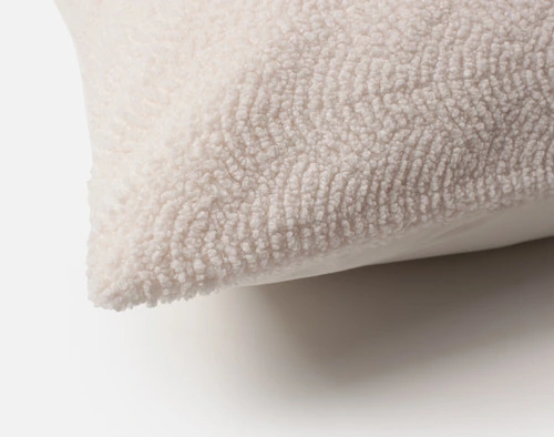 Close-up on the corner of our Ripple Boucle Euro Sham in Cream.