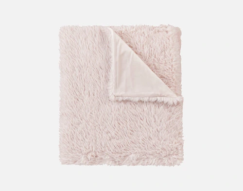 Close-up of the folded corner on our Pink Soft Mink Throw to show its smooth underside and fluffy surface.