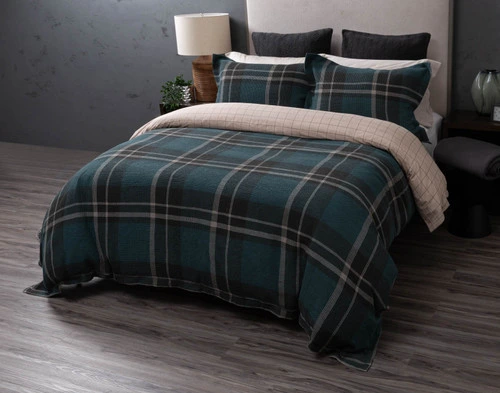 Front view of the folded edge of our Marlon Duvet Cover to show its gridline backing and green plaid surface together.