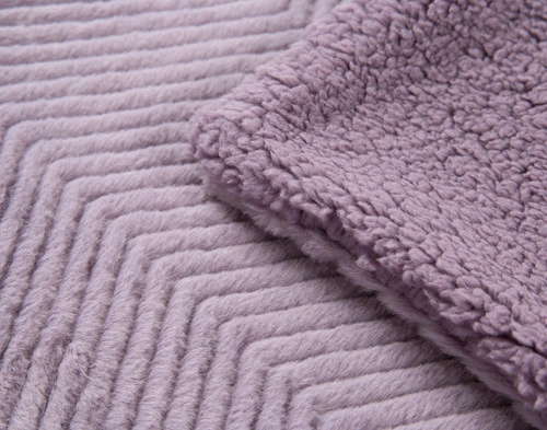 Close-up on the folded corner of our Purple Sage Chevron Etch Throw.