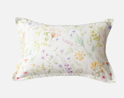 The Lena Pillow Sham featuring playful watercolour plants in a bright spring palette.