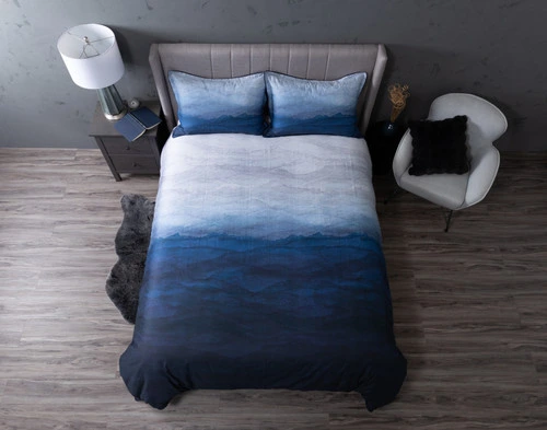 Top view of our Pacifica Duvet Cover to show its dark blue ocean-styled lower half and light blue sky-styled upper half.