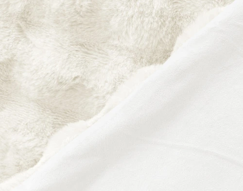 Folded side of our Bubble Faux Fur Throw in White to show its smooth velvet reverse.