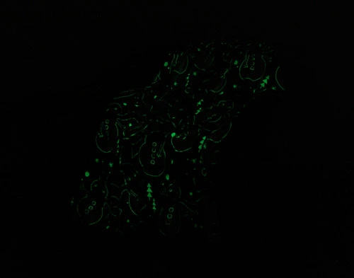 Dark view of our Frosty Glow in the Dark Fleece Throw to show its pattern glowing in a soft green.