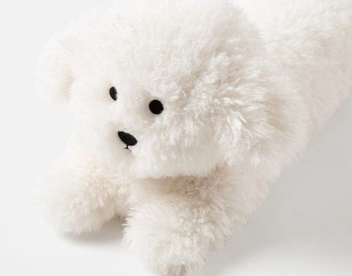 Close-up on the adorable face on the edge of our Mochi Stuffy Boudoir Cushion.