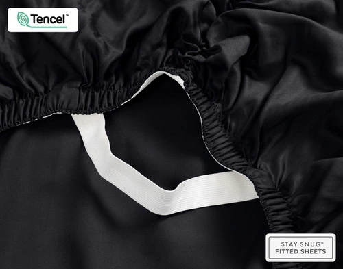 Close-up on the ruffled corner loosely resting on our BeechBliss TENCEL™ Modal Fitted Sheet in Black.