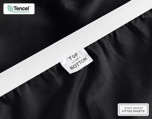 Close-up of Top & Bottom tag on the elastic of our BeechBliss TENCEL™ Modal Fitted Sheet in Black.