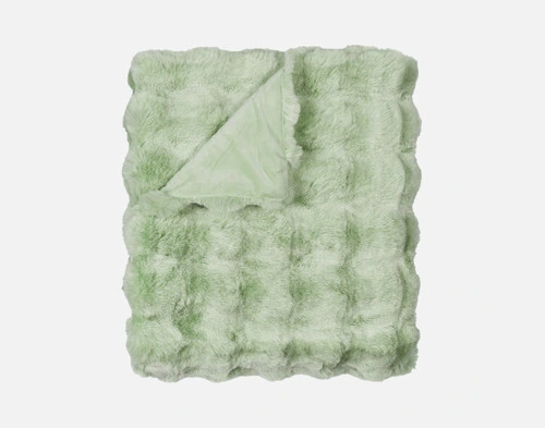 Our Green Bubble Faux Fur Throw folded into a tidy square against a solid white background.