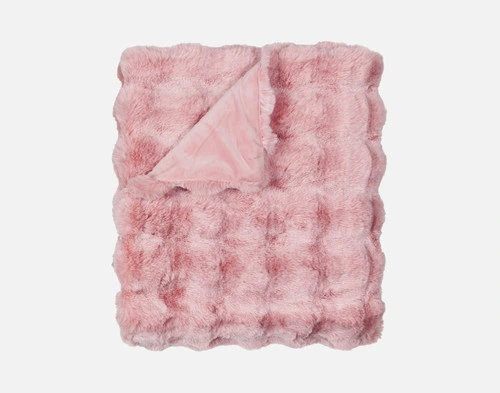 Our Pink Bubble Faux Fur Throw folded into a tidy square against a solid white background.