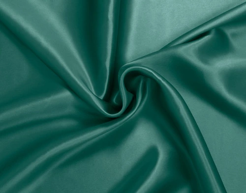 Furled up fabric on our Mulberry Silk Pillowcase in Dragonfly to show its luxuriously smooth surface.