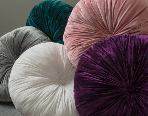 Close-up of all five colours of our Pleated Velvet Round Cushions to show their diverse styles.