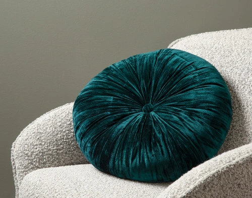 Close-up on the velvet surface and centered button detail on the center of our Ocean Pleated Velvet Round Cushion.