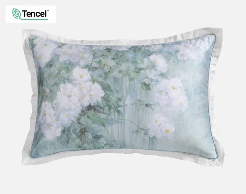 The Persuasion Pillow Sham with white flowers on a green and blue background and a white flange.