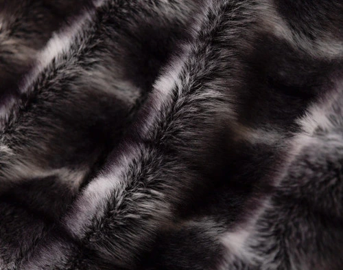 Close-up of the fluffy surface and shifting colours on our Onyx Sable Faux Fur Throw.