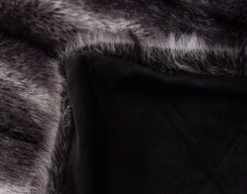 Close-up of the folded corner on our Onyx Sable Faux Fur Throw to show its smooth velvet reverse.