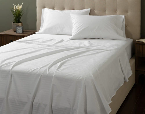 Front view of our Striped White Cotton Percale Blend Sheet Set dressed over a plain queen bed.