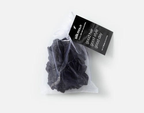 Top view of the mesh bag packaging holding our Black Mulberry Silk Scrunchie Set.