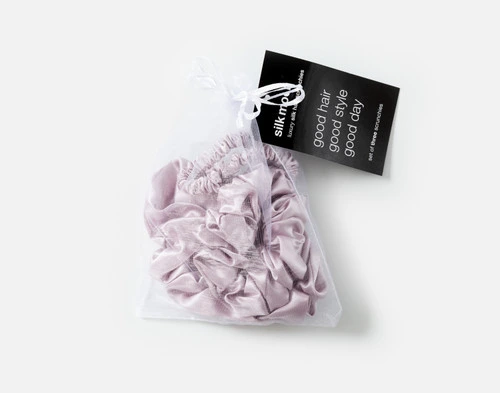 Top view of the mesh bag packaging holding our Lavender Mulberry Silk Scrunchie Set.