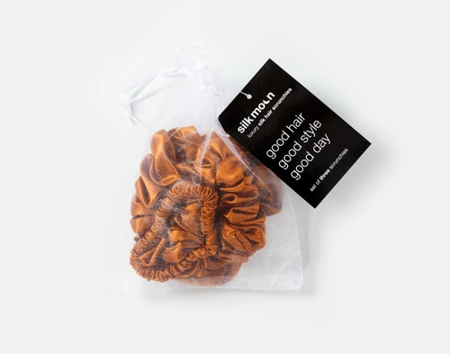 Top view of the mesh bag packaging holding our Orange Mulberry Silk Scrunchie Set.