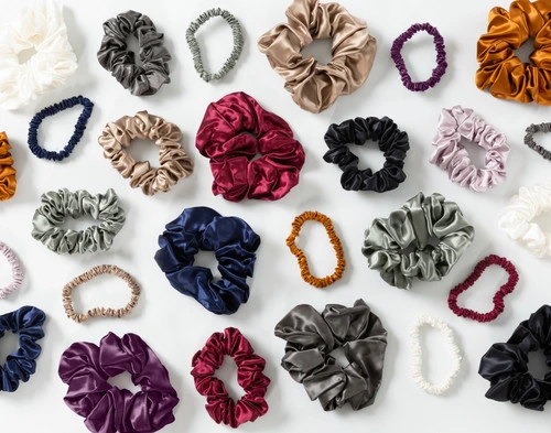 Top view of our full selection of Mulberry Silk Scrunchies, each available in a set of three with a small, medium, and large scrunchie in a matching colour.