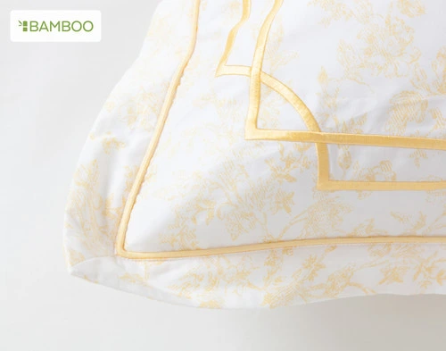 A corner of the Corsage Euro Sham with its yellow embroidery and flange detailing. 